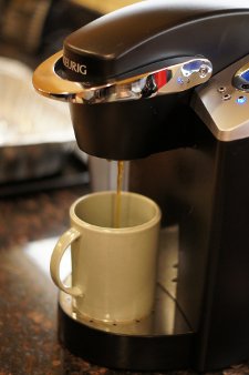 A Keurig machine brewing coffee