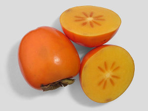 A whole persimmon and a sliced persimmon