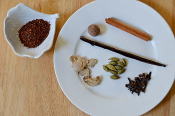 Rooibos on the left, with spices on a plate to the right