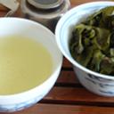 Pale green tea in a cup, and used green oolong tea leaves