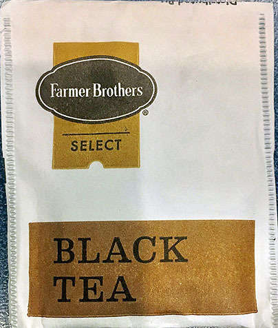 Closeup of Tea Bag Wrapper, White Background, with Farmer Brothers Select Logo, Reading Black Tea on Bronze Rectangle