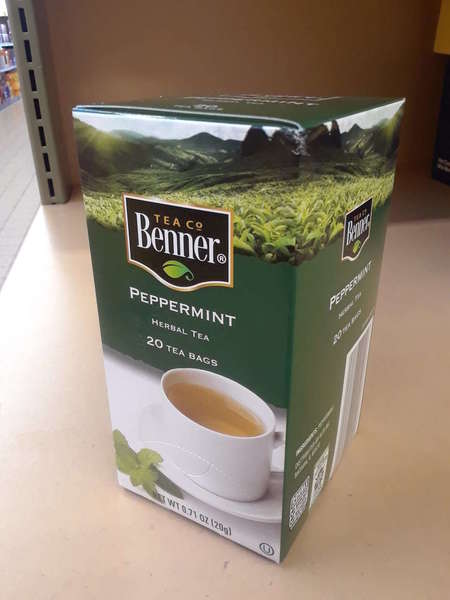 Upright box of Benner Tea Co Peppermint Herbal Tea, green color, on shelf