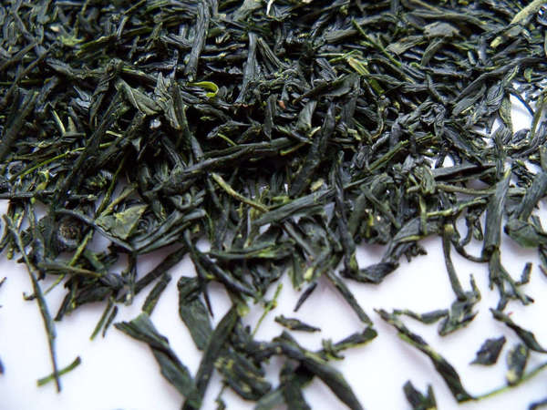 Loose-leaf green tea with long, intact leaves and intense green color