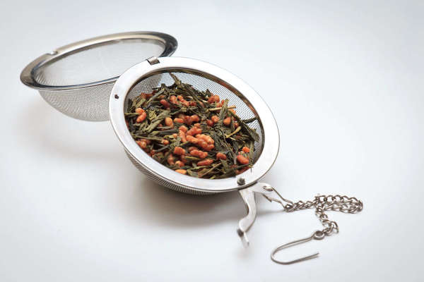 Large, open tea ball infuser filled with genmachi (green tea with puffed rice)