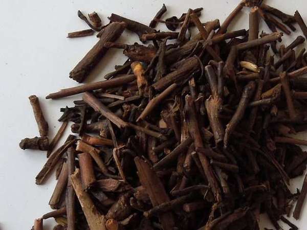 A collection of small pieces of dark brown twigs against a white background