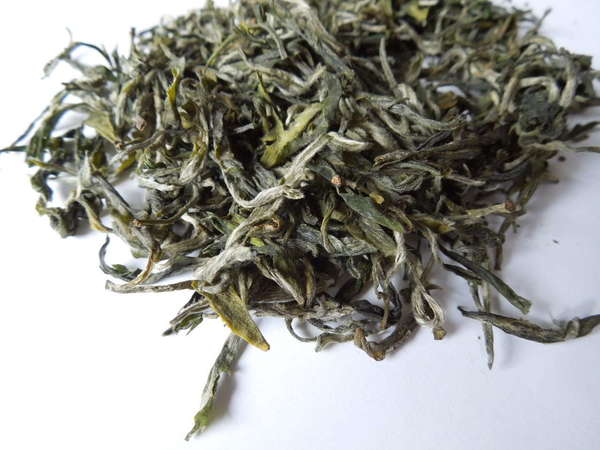 Loose-leaf green tea with many downy, silvery tips and rich green-yellow leaves