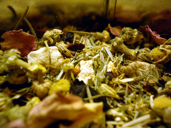Mix of various herbs, with chamomile blossoms, dried lemongrass, and flower petals visible