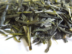 Bright green tea leaves, long and flat
