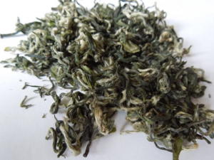 Loose-leaf green tea with downy, curly leaves