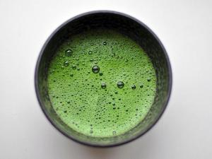 A cup of matcha, showing a foamy texture with many bubbles