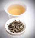 Cup of yellow tea and loose yellow tea leaf