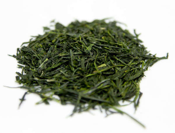 Loose-leaf green tea with vibrant green color, long, flat, slightly flakey but intact leaves