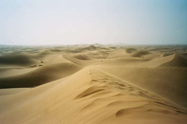 Windswept sand dunes in desert with no sign of any life in sight