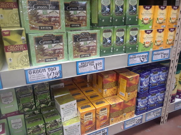 Boxes of teabags on a shelf, mostly Trader Joe's brand, in a Trader Joe's store