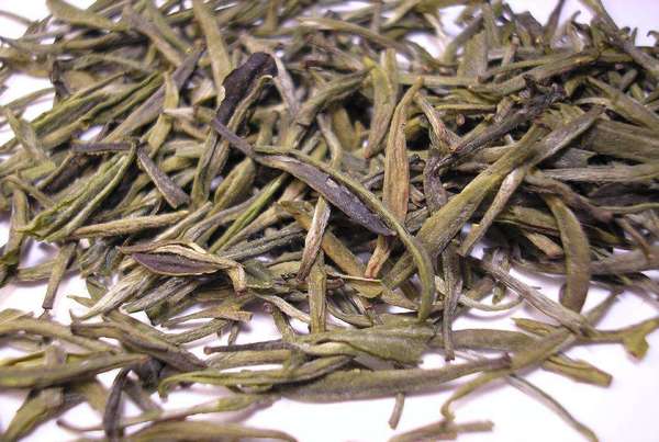 Thick, supple-looking tea buds with yellow-green color and dusty texture