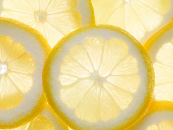 Lemon cross-sections with light shining through from behind, bright yellow