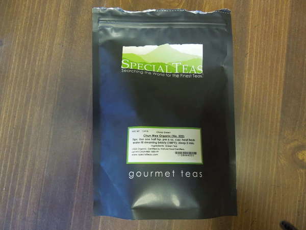 Black bag with green SpecialTeas logo, reading Chun Mee Organic (No. 522), Gourmet Teas