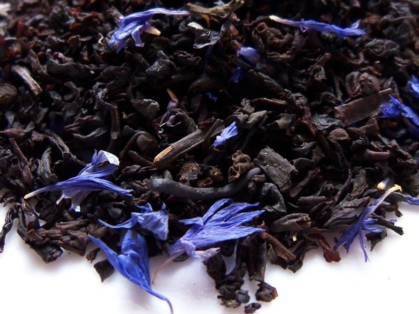 Very dark loose-leaf black tea with bright blue dried flowers mixed in