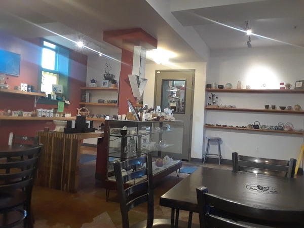 Tea shop interior showing a bunch of small teaware and some tables